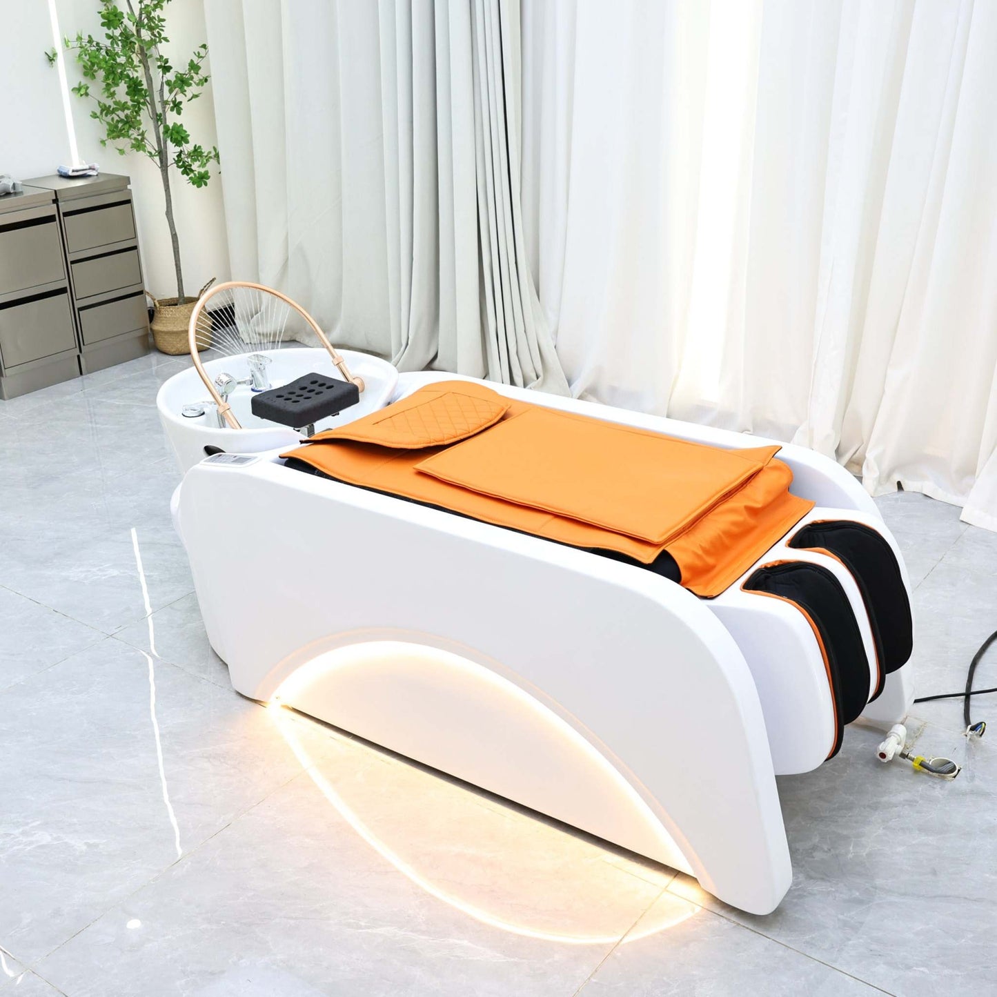 Advanced beauty spa equipment with a transparent dome and cushioned orange bedding.